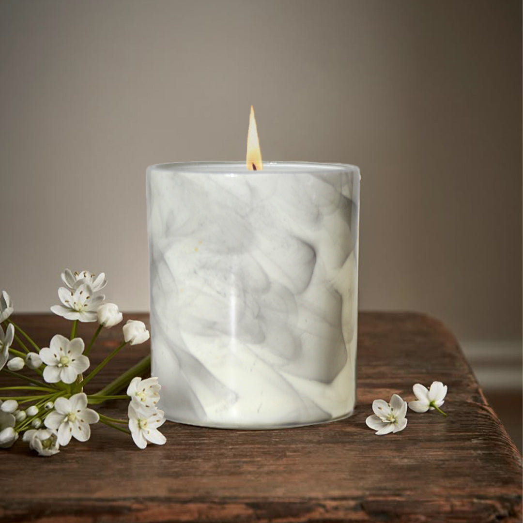 artkart Elegant Earthen Beauty Marbled Serenity Scented Candles - Lifestyle Image of artkart Elegant Earthen Beauty Marbled Serenity Scented Candles with Flowers